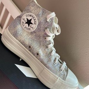 Silver/grey hightop converse w/ platform bottom. White laces.